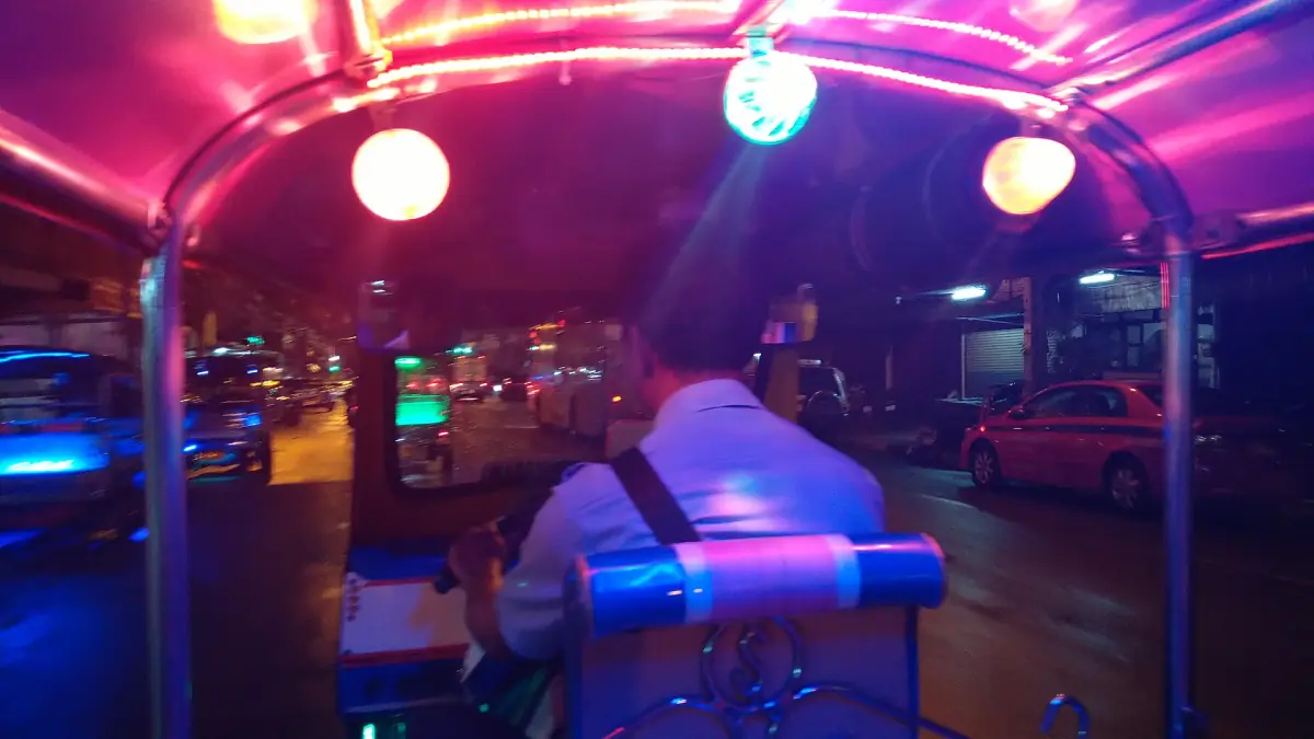 Riding a tuk-tuk in Bangkok at night